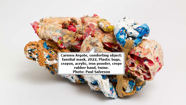 click to enlarge- double click to reduce Carmen Argote, comforting object: familial mask, 2022, Plastic bags, crayon, acrylic, iron powder, crepe rubber band, twine. Photo: Paul Salveson