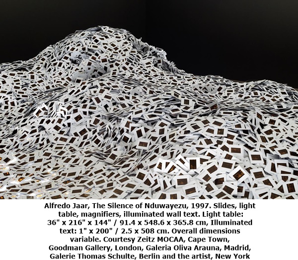 click to enlarge- double click to reduce Alfredo Jaar, The Silence of Nduwayezu, 1997. Slides, light table, magnifiers, illuminated wall text. Light table: 36' x 216' x 144' / 91.4 x 548.6 x 365.8 cm, Illuminated text: 1